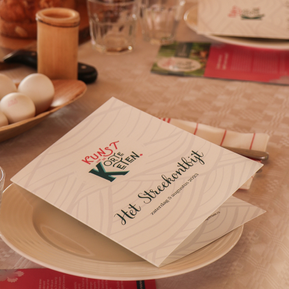 Een gedekte tafel met streekproducenten en menukaart